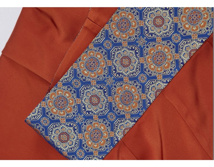 Detail of rust-orange skirt paired with brocade waist belt on tang-style hanfu dress