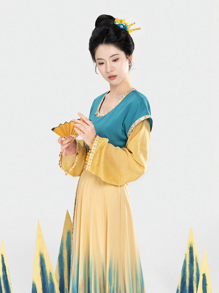 Model holding a flower while wearing Tang style ethnic Hanfu dress