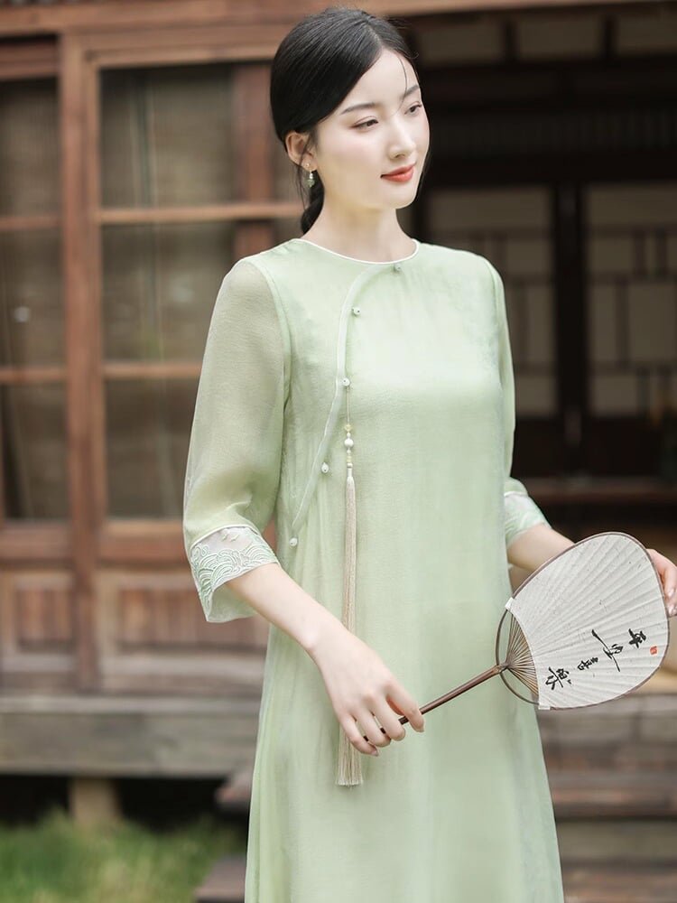 Half-body close-up of woman in light green Tencel tea dress