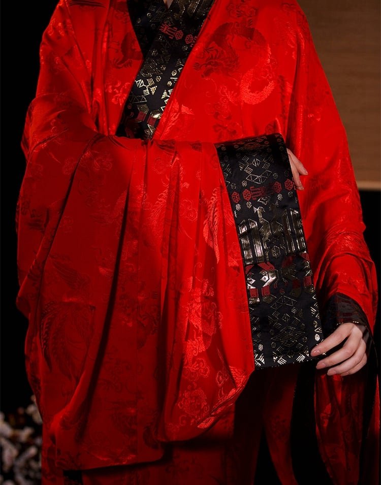 Close-up of red inner robe and gold brocade sleeve trim in Snake Year edition.
