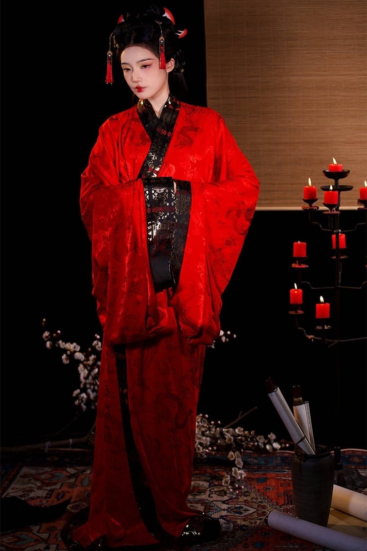 Red inner robe worn under black outer Hanfu robe for Snake Year layered contrast.