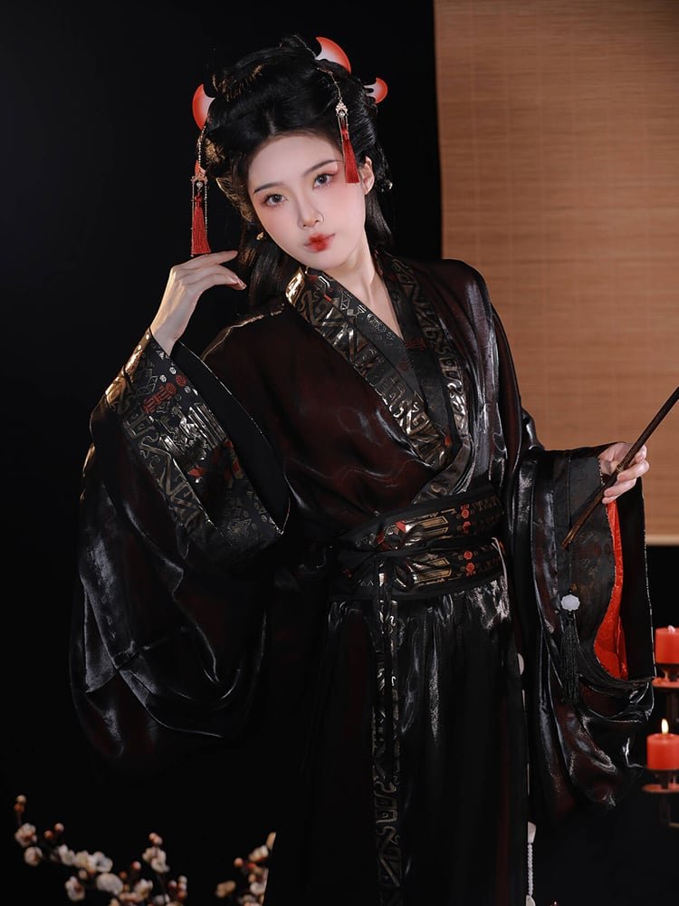 Seated pose showing the glossy jacquard satin texture and ornate sleeve details.