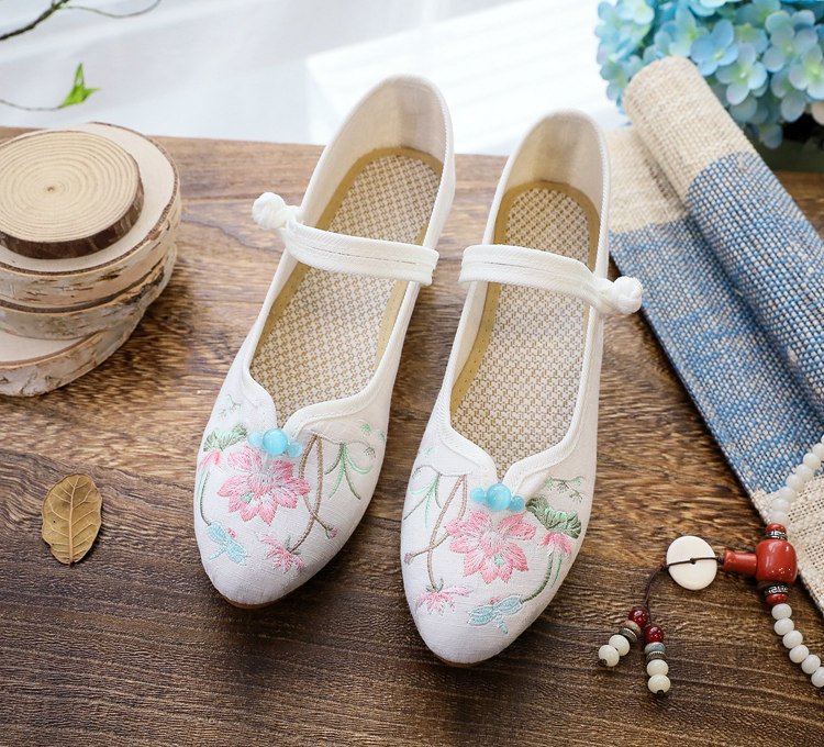 White embroidered Mary Jane pumps with floral design