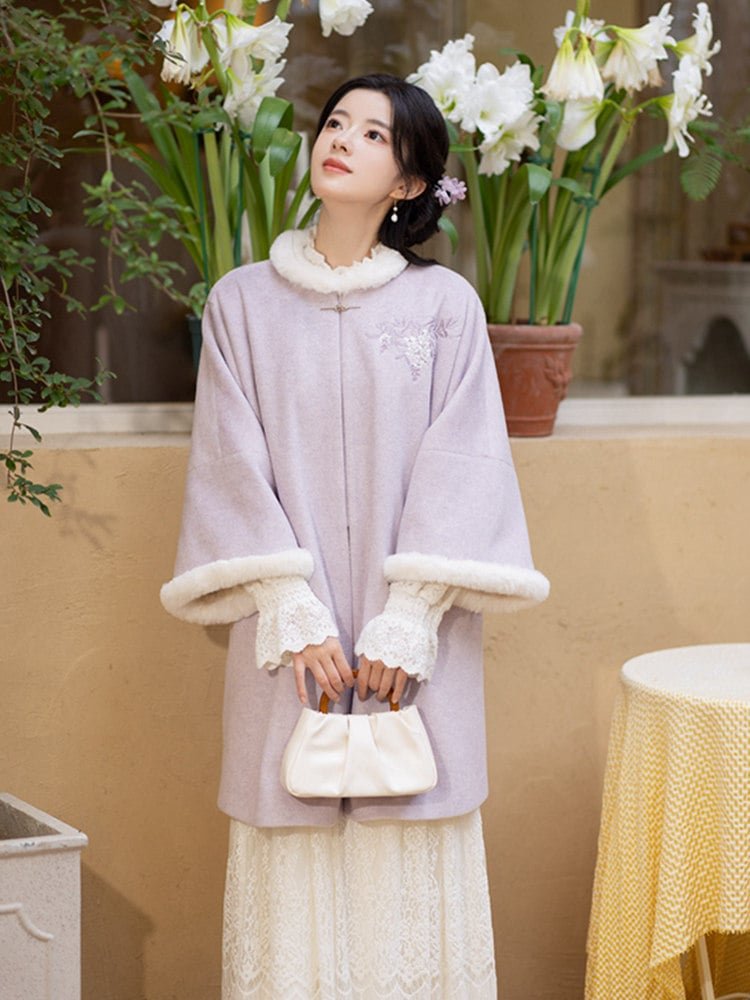 Woman wearing a lavender Hanfu winter coat with white fleece cuffs and collar