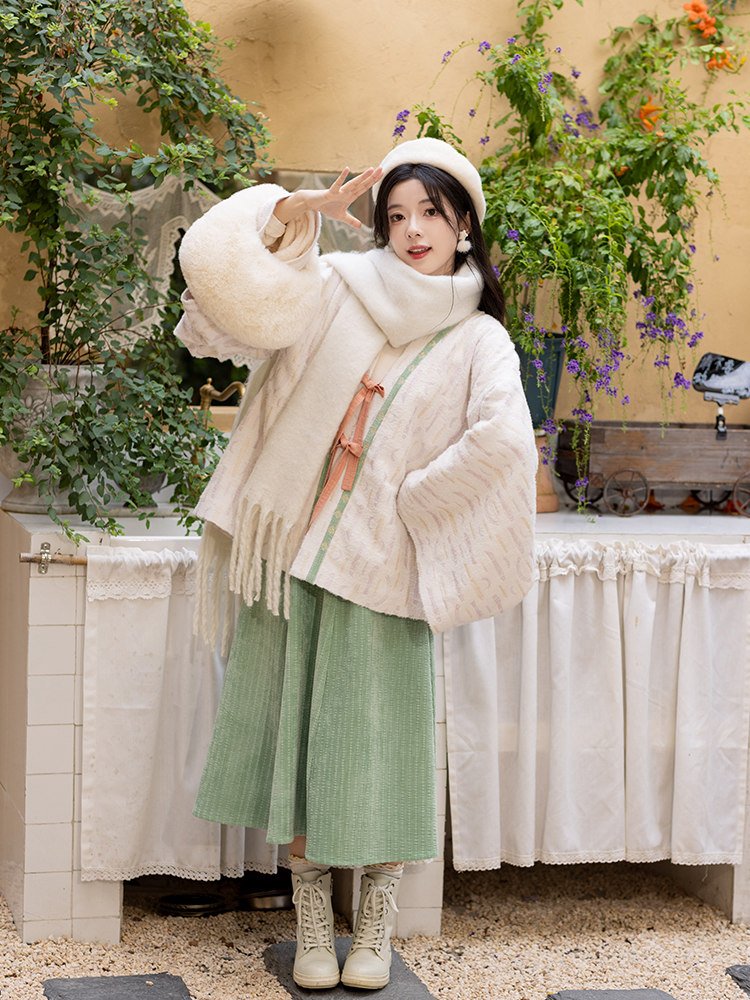 Woman wearing Jin dynasty Hanfu posing outdoors in garden.