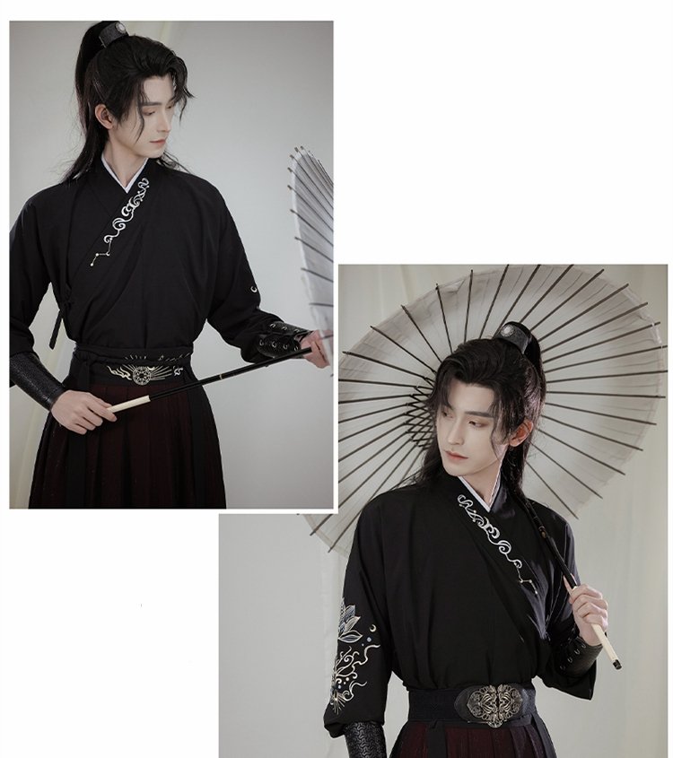 Model wearing black embroidered Wuxia Hanfu robe holding a fan, ancient martial style.