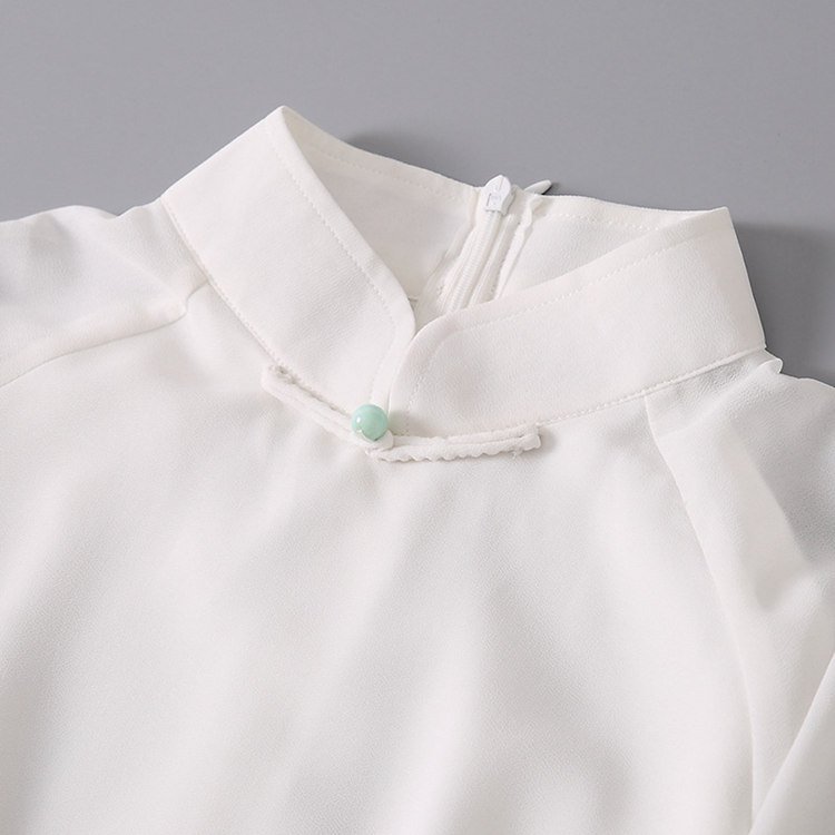 Close-up of handmade frog buttons on chiffon tea dress