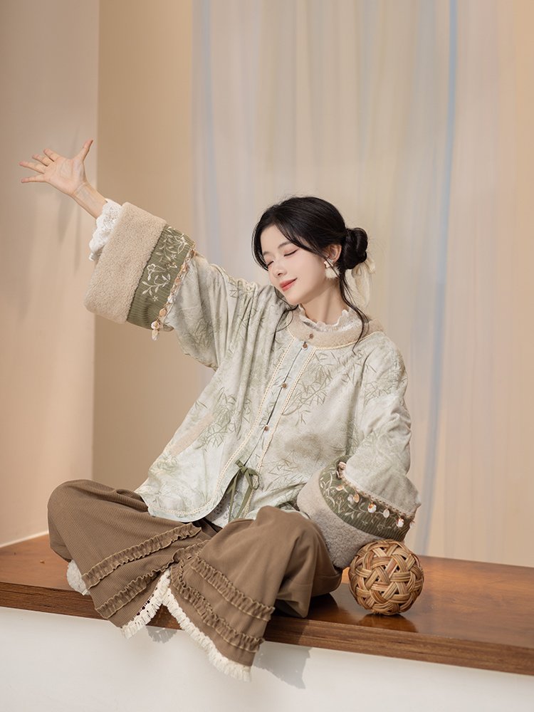Seated pose showing the Mist Bamboo Hanfu jacket details.
