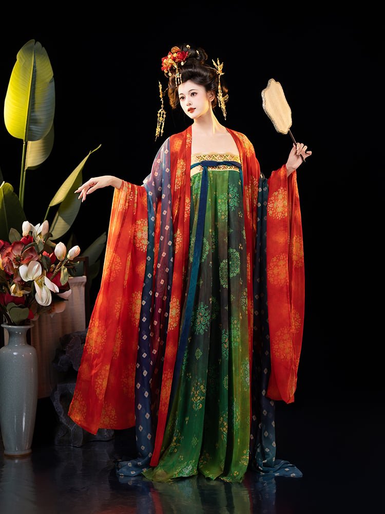 Model wearing Dunhuang style Hanfu dress with red wide sleeves and green gradient ruqun