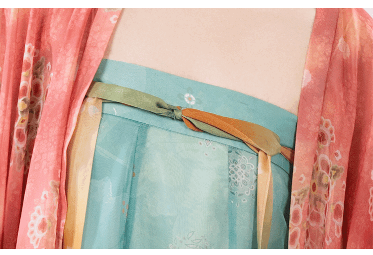 Close-up shot of the bust area showing embroidery, trims, and color details.