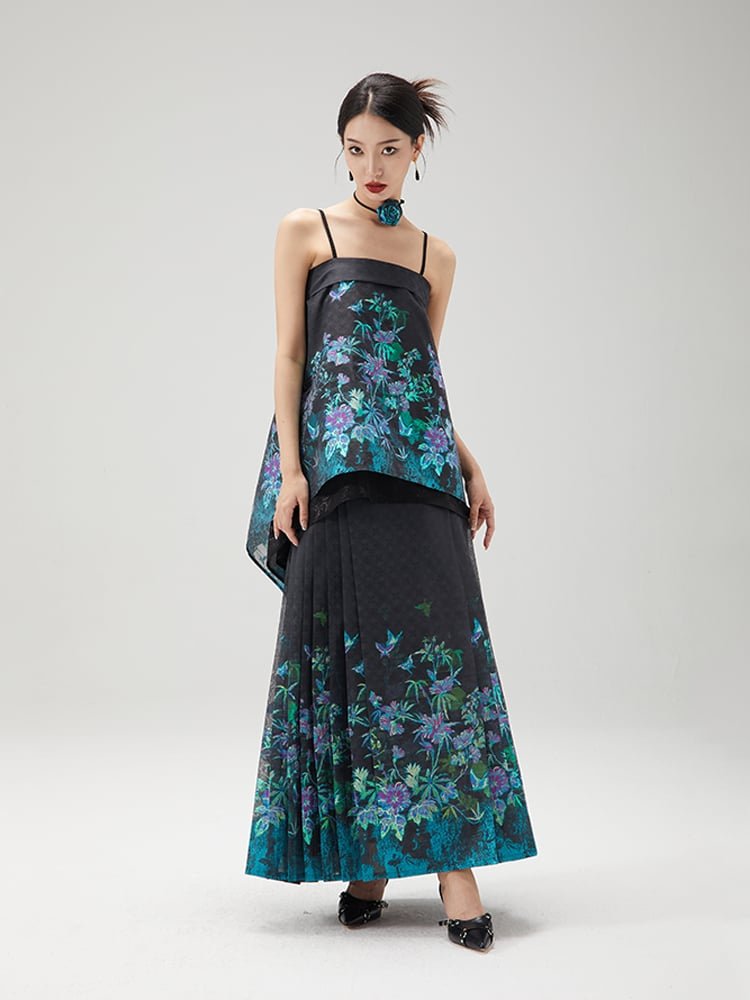 Model showing side view of layered black top with embroidered floral skirt
