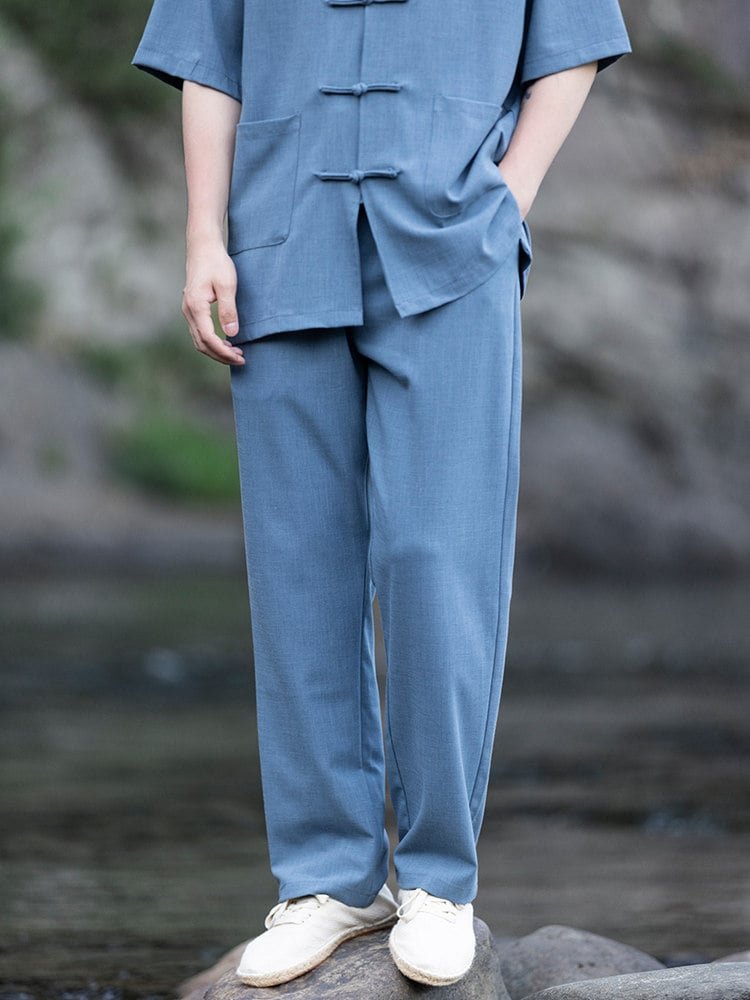 Close-up of the blue loose-fit pants from a men’s Chinese summer outfit, photographed outdoors.