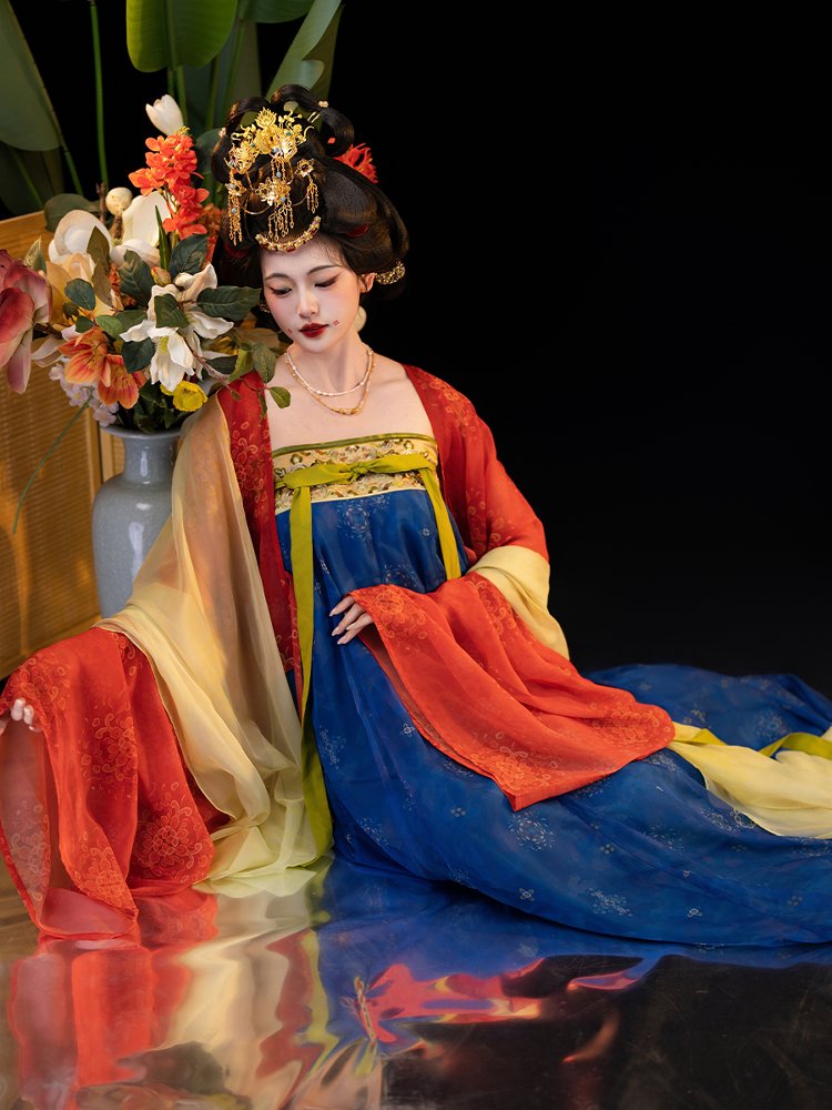 Sitting pose of the model wearing the Star Bridge Tang Dynasty ruqun in a floral studio setting.