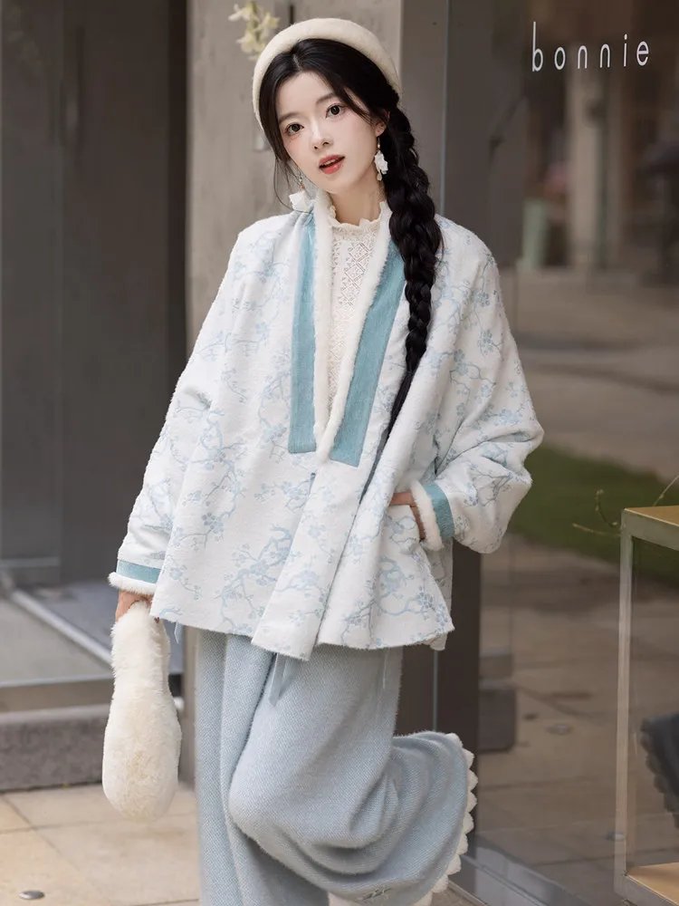 Model wearing blue Plum Blossom Hanfu jacket in winter